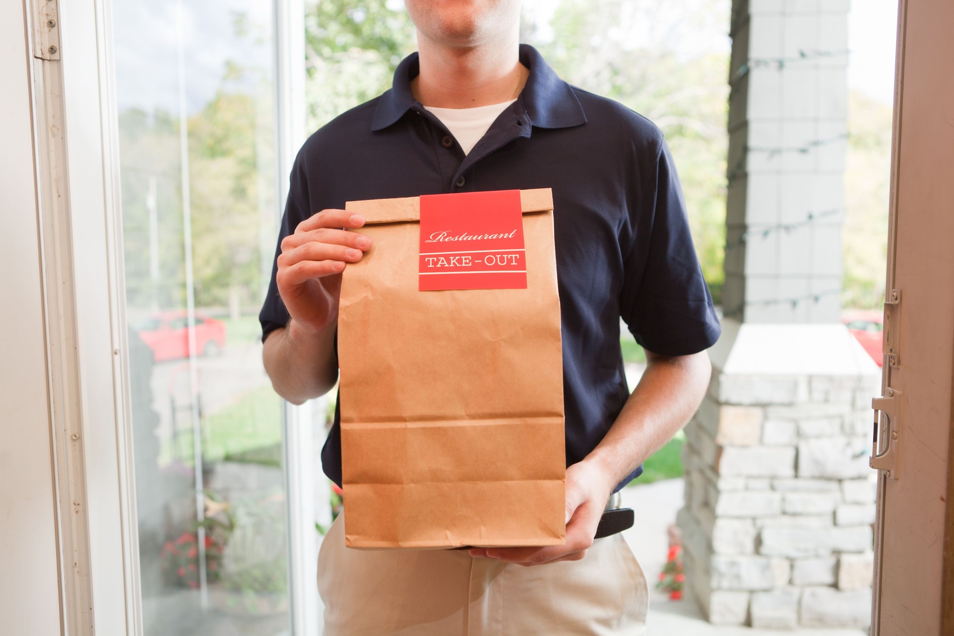 Restaurant Take-out Package Delivery to the Customer's Door Close-up